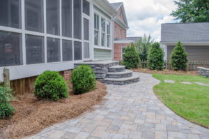 Seamless transition from screened porch to patio in outdoor living space