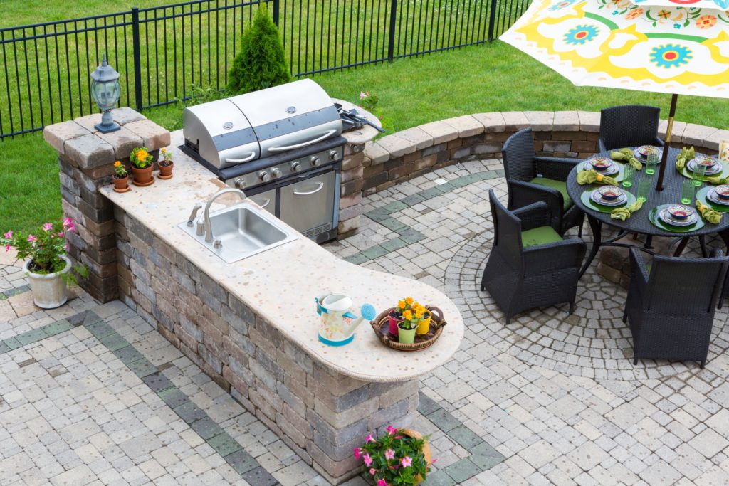 Nice outdoor kitchen and patio with sink and grill.