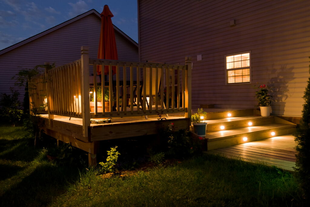 A deck with landscape lighting.