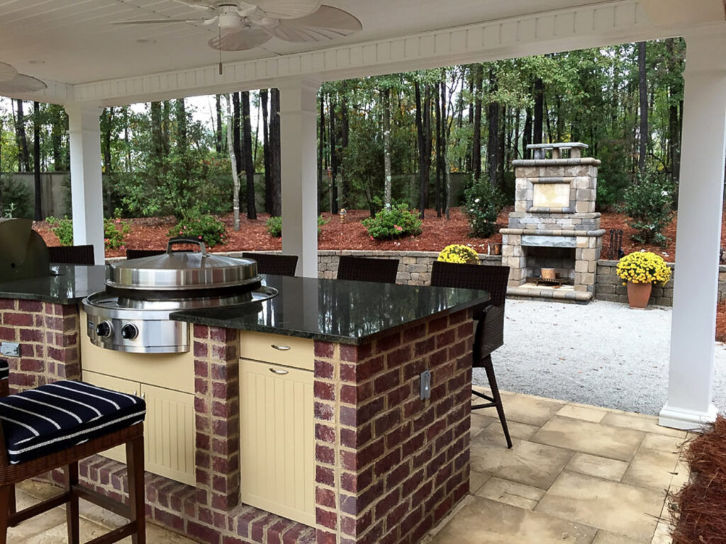 Outdoor kitchen and fireplace in Augusta, GA by Verdant Landscaping.